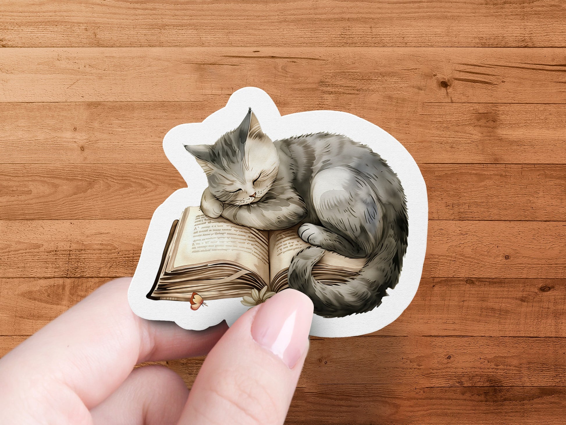 Cute Sleepy Cat Resting On Open Book Sticker product
